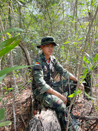 Portrait of man standing in forest