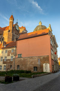 Low angle view of buildings in city against sky