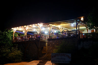 Illuminated built structure against sky at night