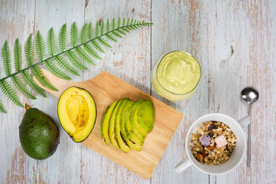 Healthy eat and lifestyle with avocado slice ,smoothie and breakfast on wooden background