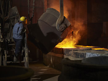 Industry, liquid copper is filled into mold, worker controlling