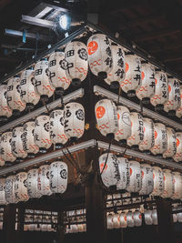 Low angle view of illuminated lanterns hanging by building