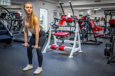 Young woman exercising in gym