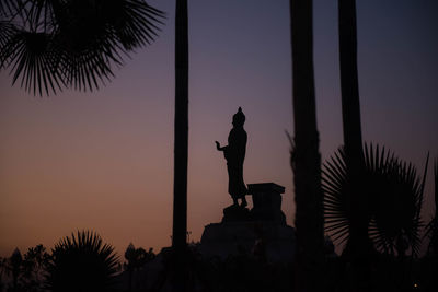 Silhouette statue against clear sky at sunset