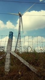 Windmill on field against sky