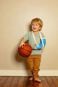 Portrait of boy playing basketball