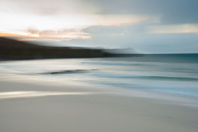 Scenic view of beach against sky during sunset