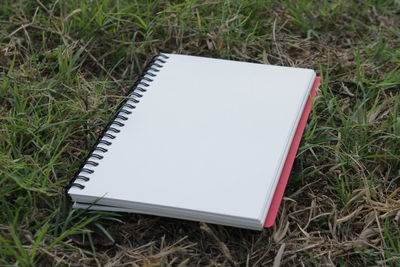 High angle view of open book on field