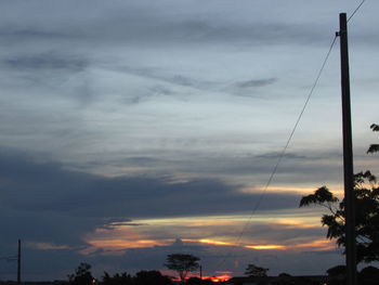 Low angle view of trees against sky during sunset