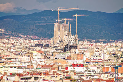 High angle view of buildings and sagrada familia in city, barcelona 