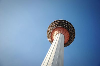 Low angle view of kuala lumpur tower against blue sky