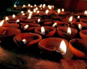 Close-up of lit diyas