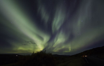 Scenic view of landscape against sky at night