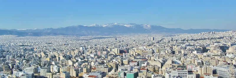 High angle view of cityscape against blue sky