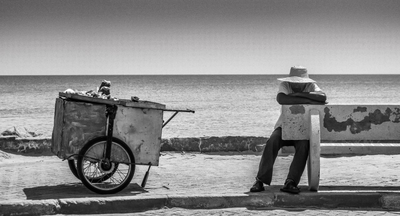 sea, horizon over water, water, transportation, bicycle, mode of transport, clear sky, beach, copy space, shore, tranquility, men, tranquil scene, nature, scenics, nautical vessel, beauty in nature, railing, rear view