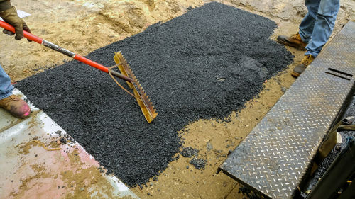 Low section of construction workers working on road
