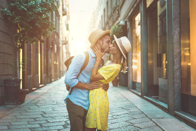 Smiling couple standing amidst alley