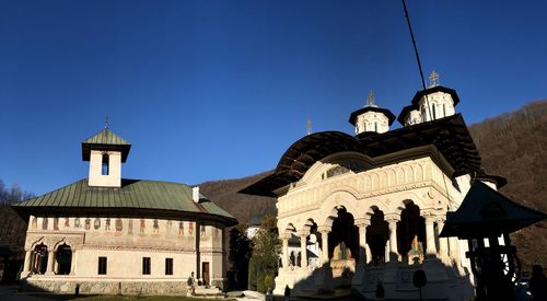 Low angle view of historic building against clear blue sky