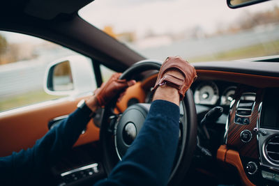 Midsection of man driving car