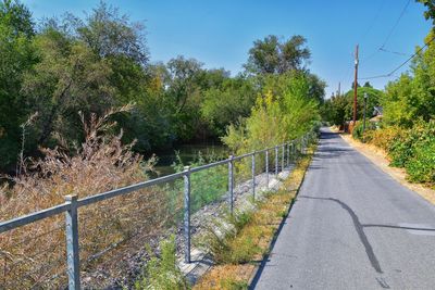 Road amidst trees against sky