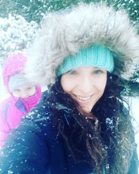 Portrait of smiling woman in snow