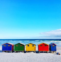 Scenic view of beach against blue sky