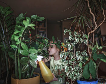 Portrait of woman with potted plants