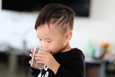 Close-up of boy drinking water