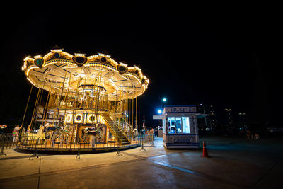 Illuminated ferris wheel at night