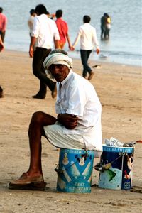 Rear view of a woman sitting on beach