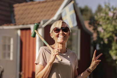 Happy woman holding croquet mallet