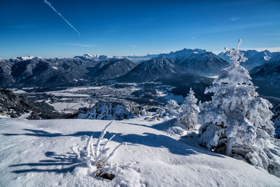 Scenic view of snowcapped mountains against blue sky
