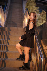 Portrait of young woman standing in building