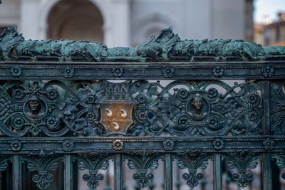 Close-up of statue against historic building