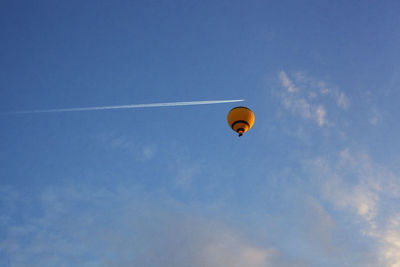 Low angle view of hot air balloon against blue sky