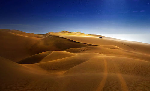 Scenic view of desert against sky at night