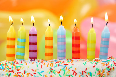 Multi colored candles on birthday cake