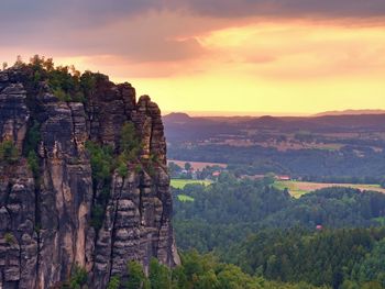 Sharp sandstone cliffs above deep valley. popular climbers resort. rocks sticking up from forest 