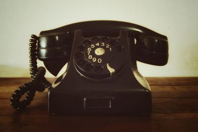 Close-up of telephone booth on table