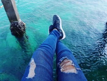Low section of woman with legs in water
