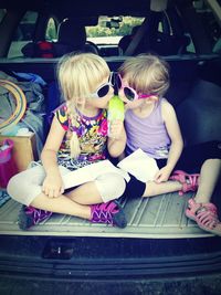 Cute girls having ice cream in car