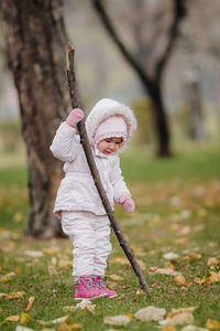 Close-up of girl with tree trunk