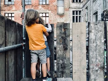 Rear view of boy on wall