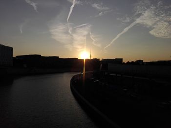 Silhouette buildings against sky during sunset