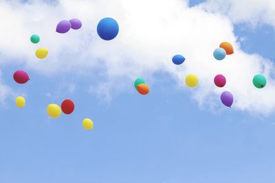 Low angle view of balloons against sky