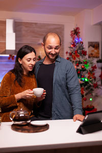 Young woman with coffee on table at home