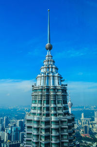 Modern buildings in city against blue sky