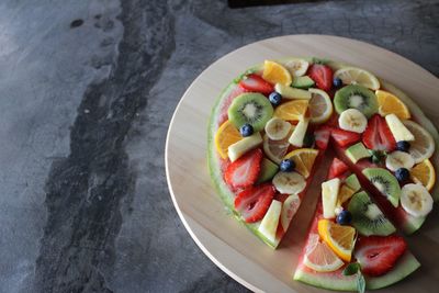 High angle view of various chopped fruits in plate