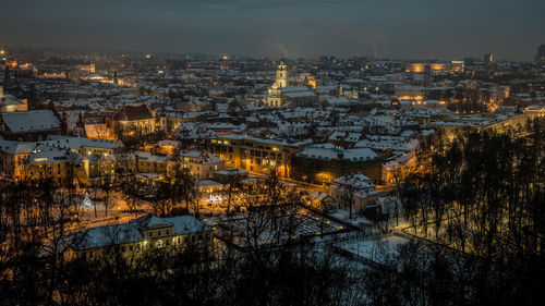 High angle view of illuminated buildings in city at night