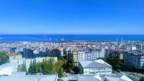 High angle view of townscape against clear blue sky